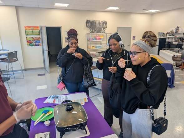 Students tasting samples of food.