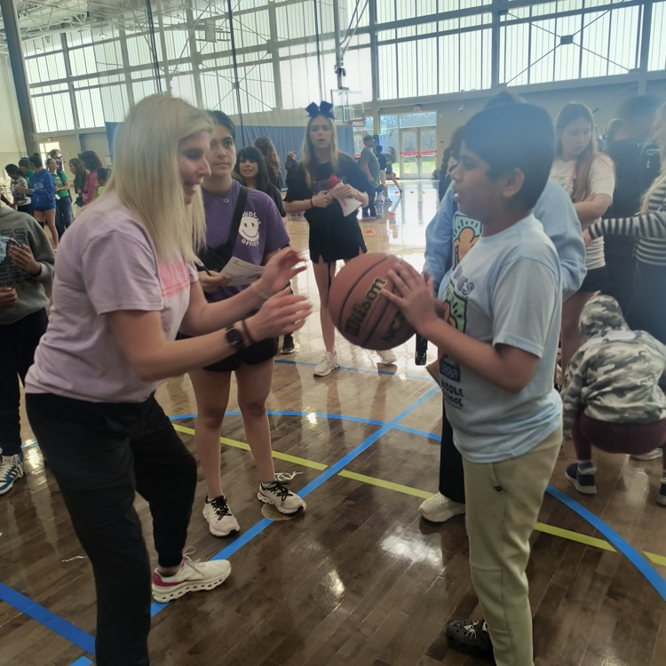 student and coach playing basketball