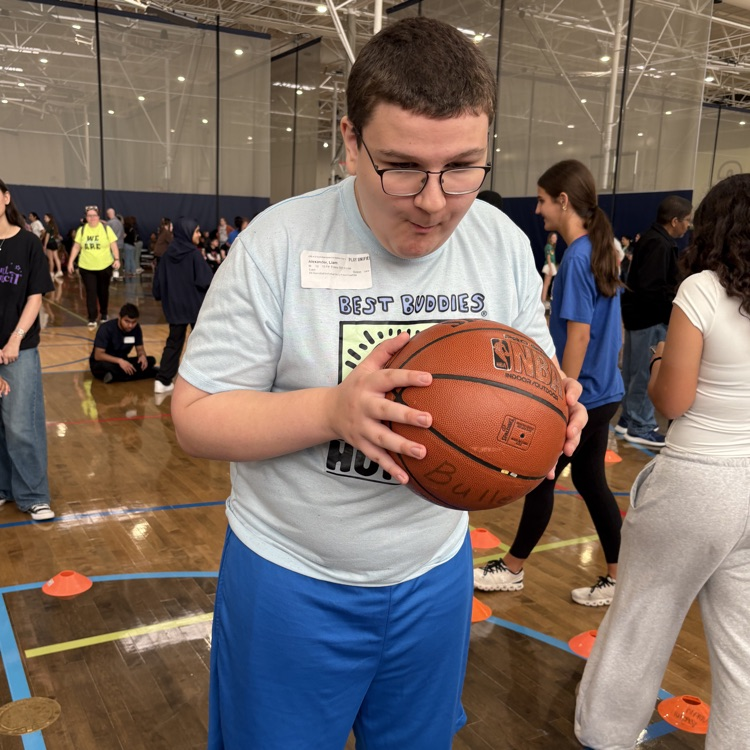 student holding basketball