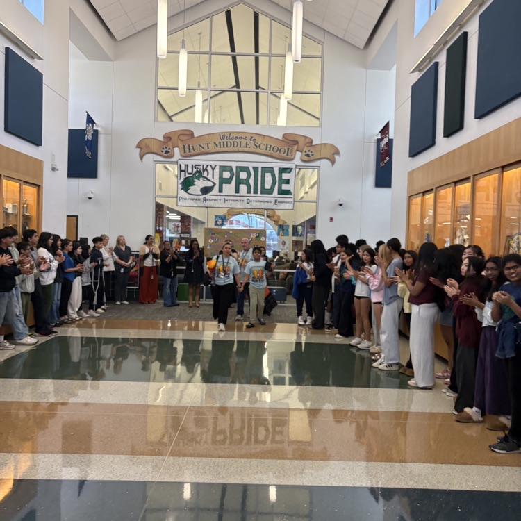Students and staff lining the hallways to send off students as they go to the Special Olympics