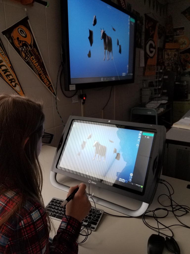 This student is dissecting a 3D cow.  She sees it in 3D and the class sees it in 2D.