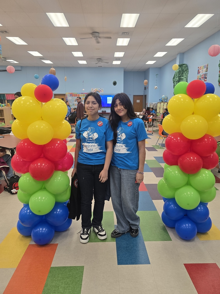 2 girls standing in front of balloons