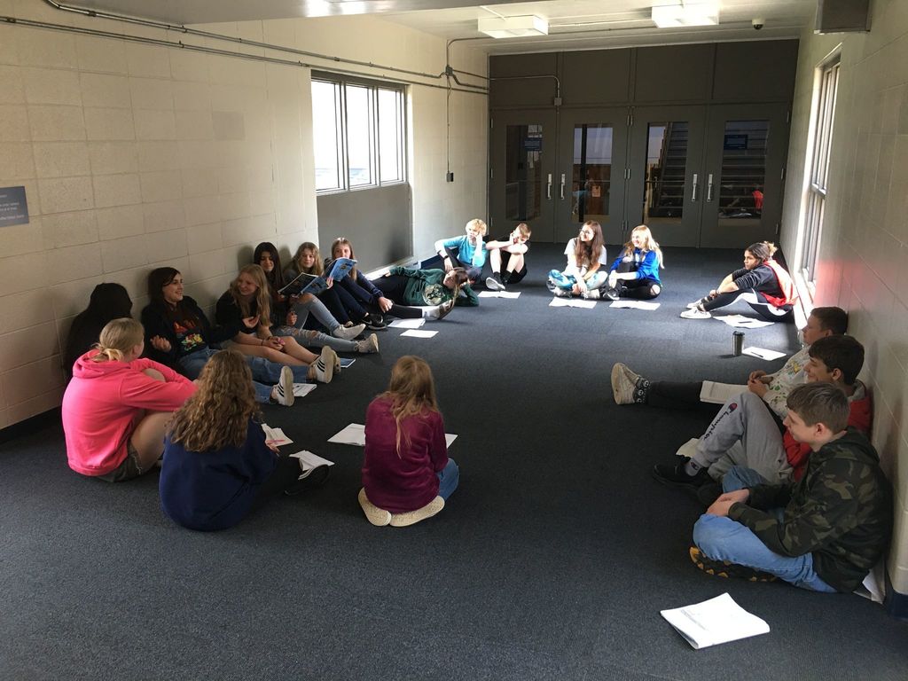 Students sitting on floor discussing