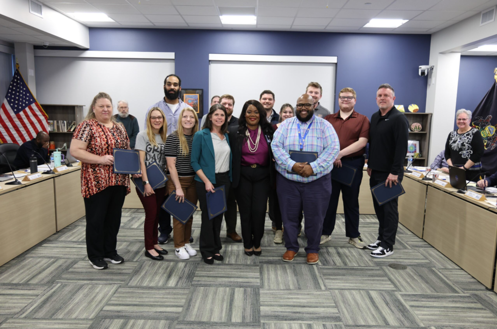 Staff standing with Dr. Natalyn Gibbs after receiving their Bravo Awards. 