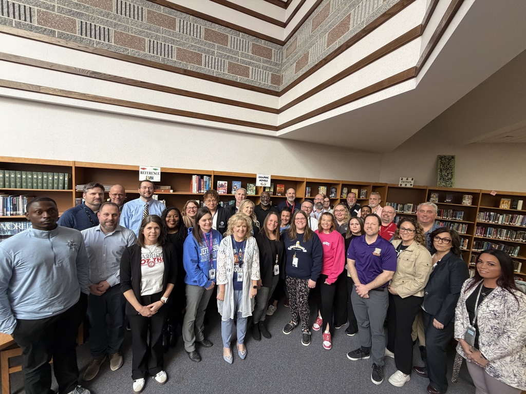 A group photo of Assistant Principals in a Library.
