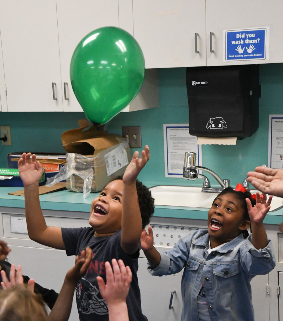 students playing with a balloon