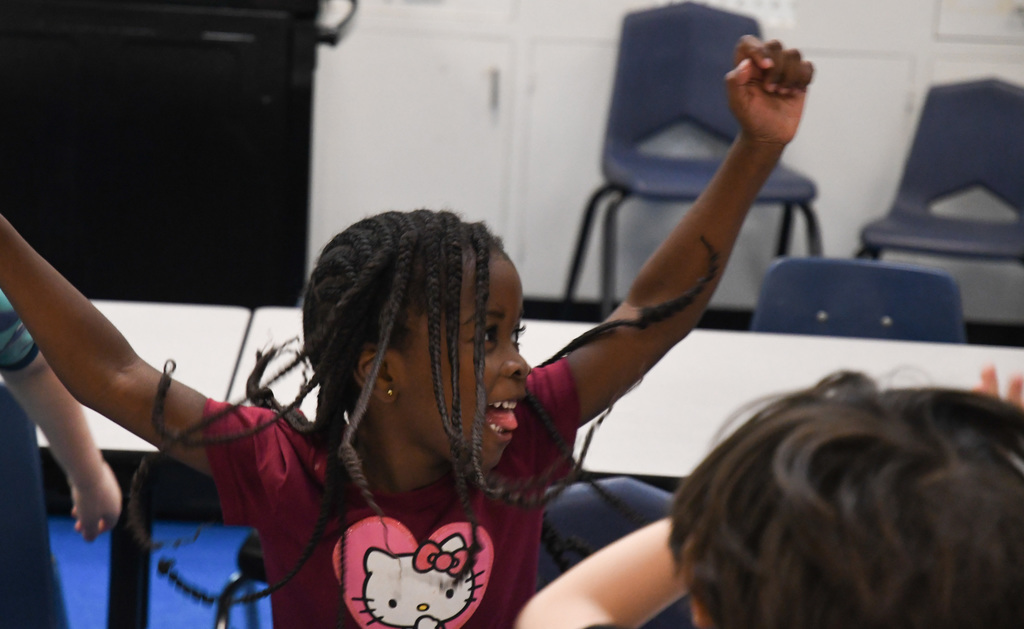 child doing jumping jacks