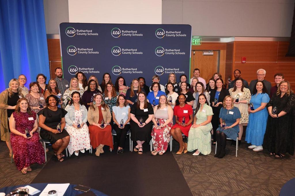 Smiling teachers holding awards