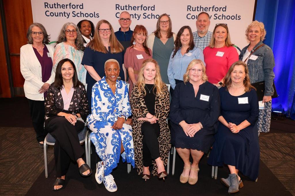 A group of smiling teachers and principals