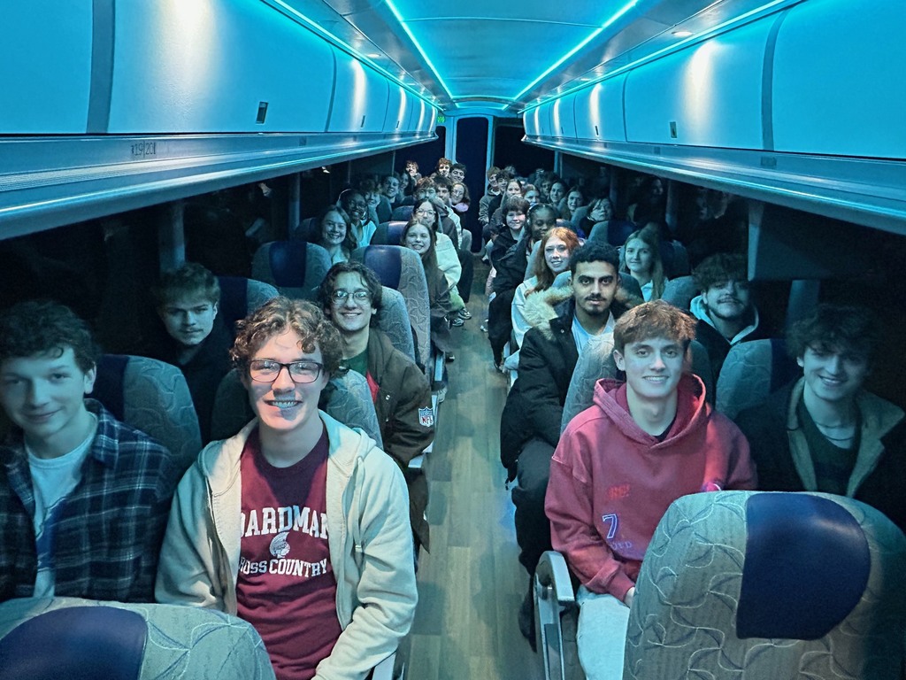 students on a charter bus ready for NYC Trip