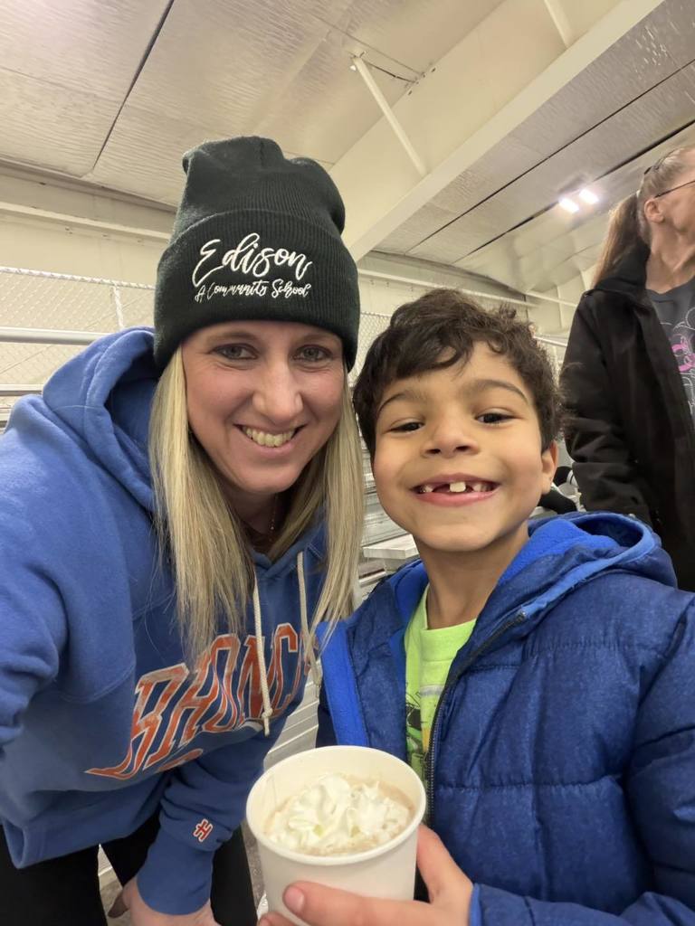 A teacher and students smiling. 