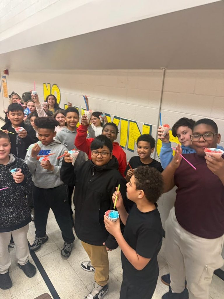 Students eating snow cones in a lunch cafeteria. 