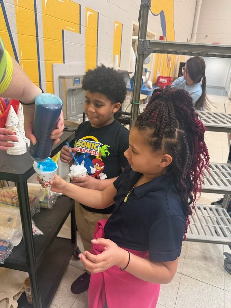 Students getting flavor added to their snow cone. 