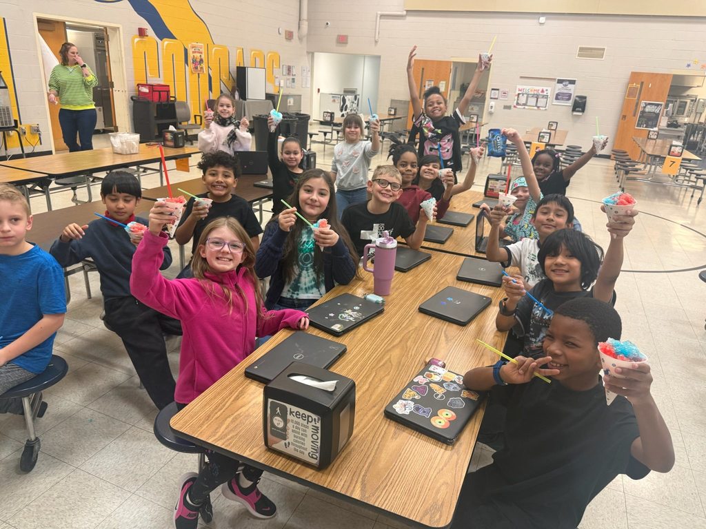 Students eating snow cones in a lunch cafeteria. 