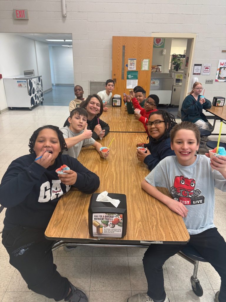 Students eating snow cones in a lunch cafeteria. 