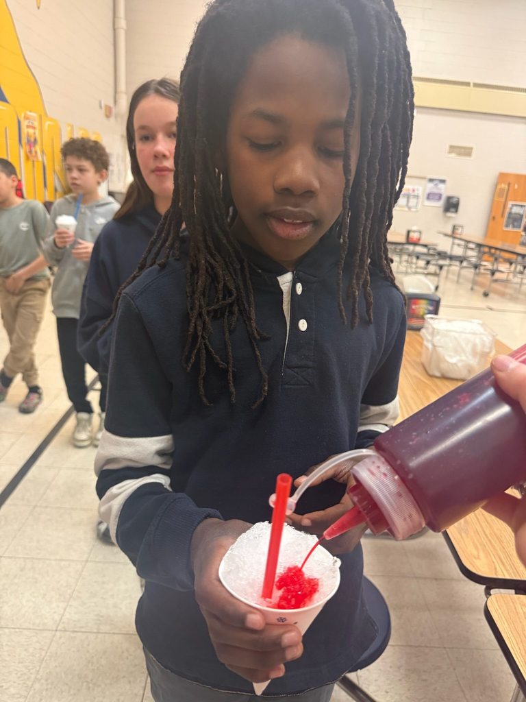 Student getting flavor added to their snow cone. 