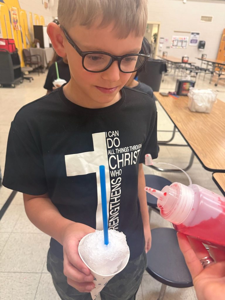 Student getting flavor added to their snow cone. 