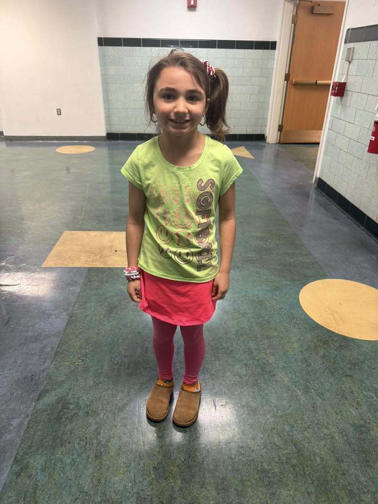 A young girl dressed in bright 80s clothing. 