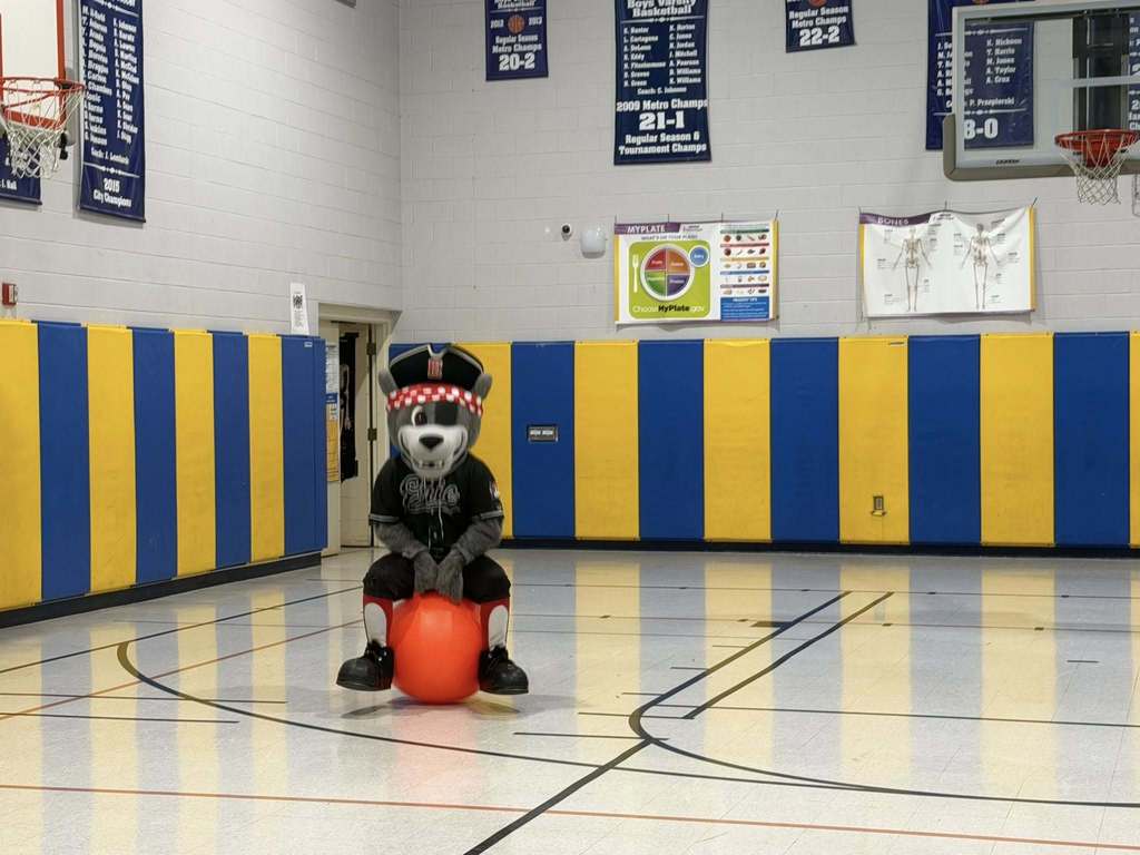 The Erie SeaWolves mascot jumping on a ball. 