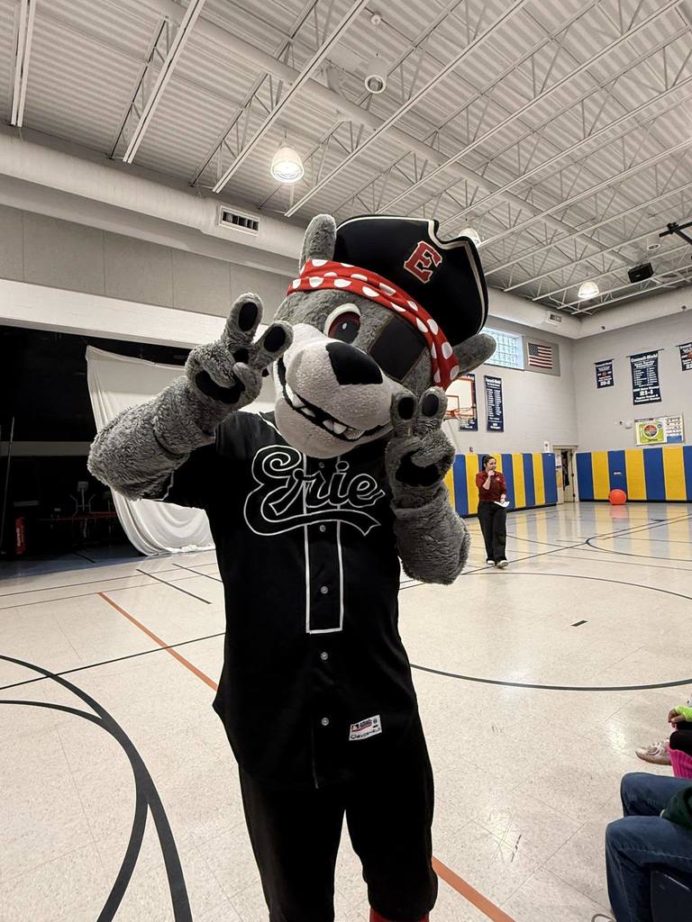 The Erie SeaWolves mascot holding up peace signs. 