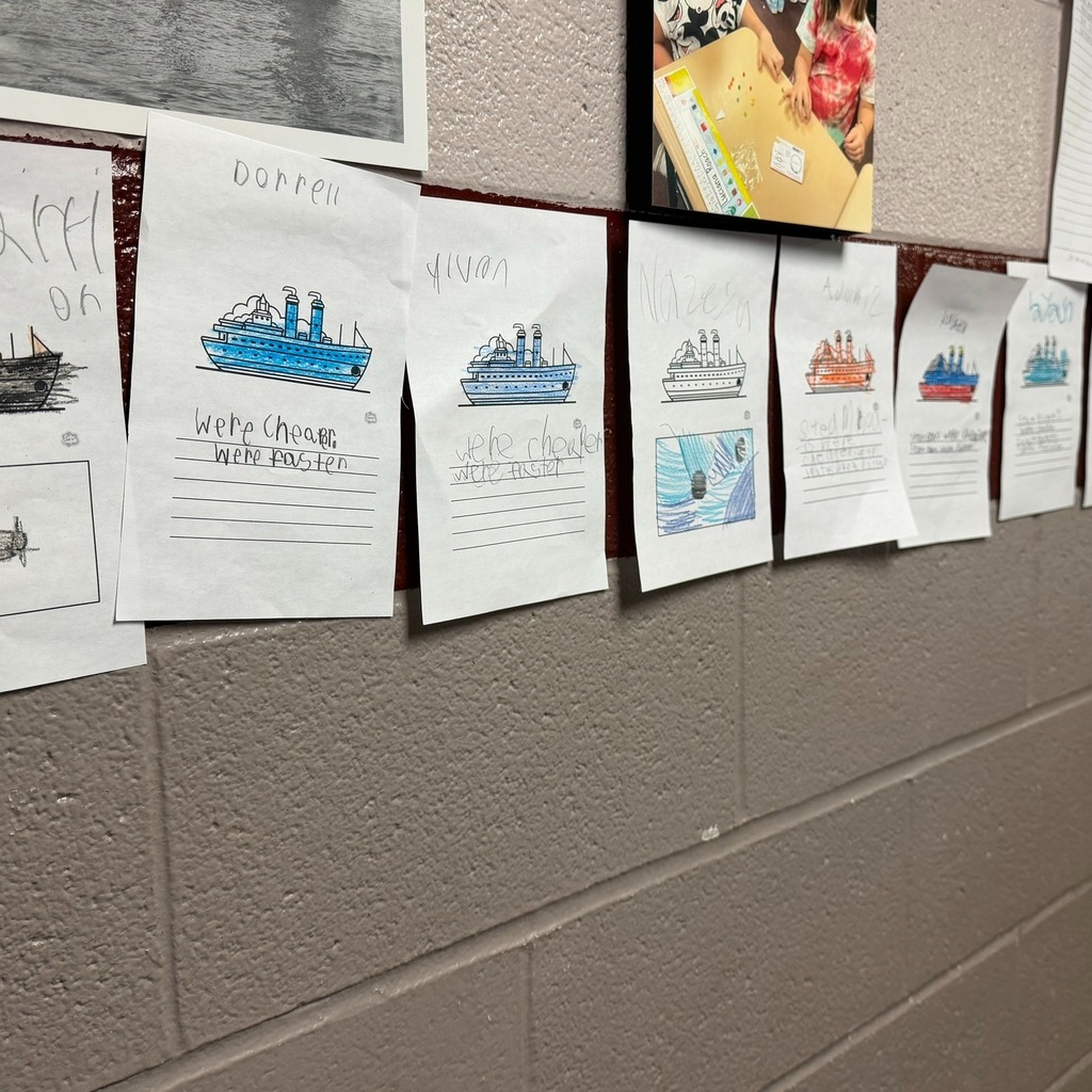Boats on paper colored with writing under them.
