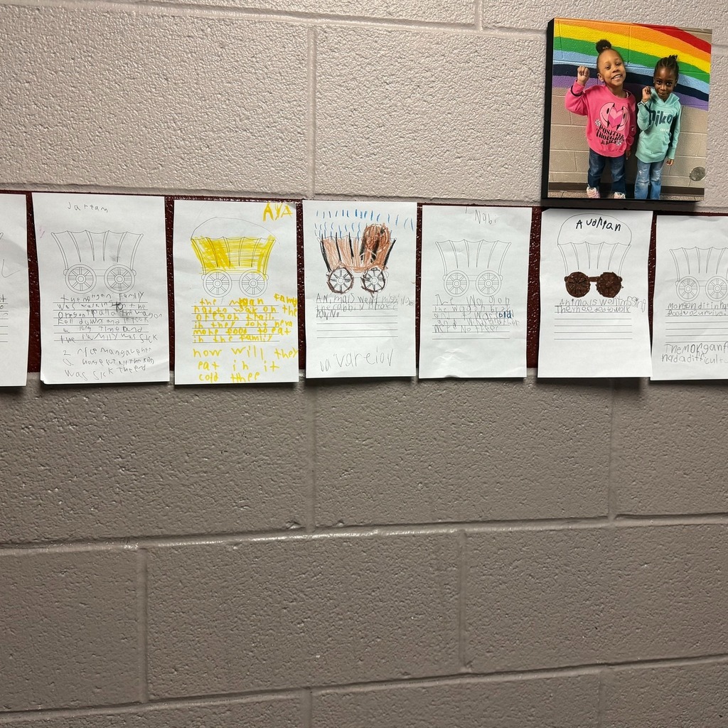 Wagons on paper colored with writing under them.