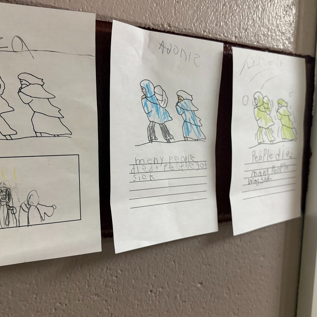 Two people walking on paper colored with writing under them.