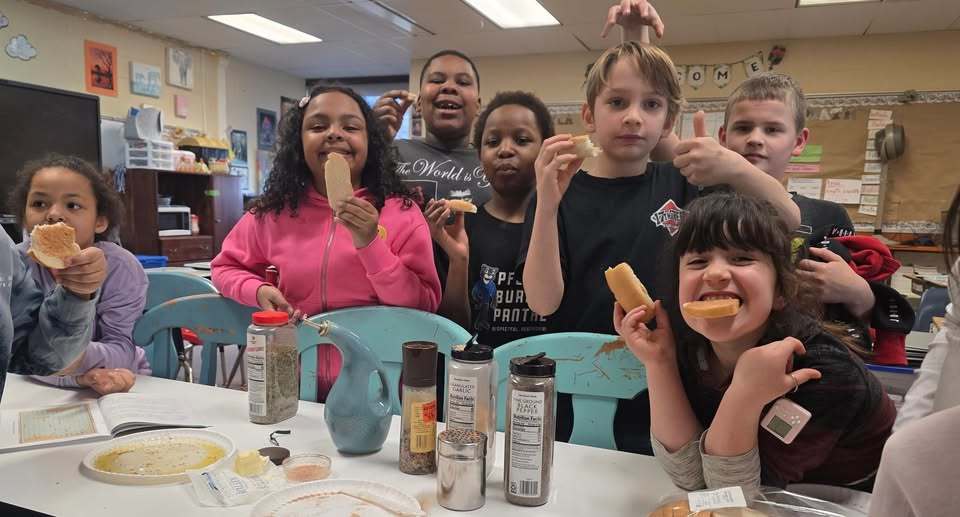 Students eating food with spices on them. 