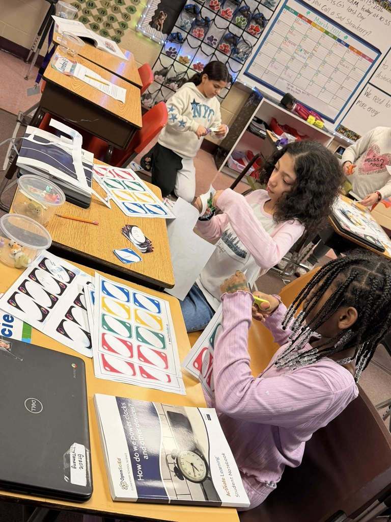 Students cutting blank Uno Card that are printed on paper. 