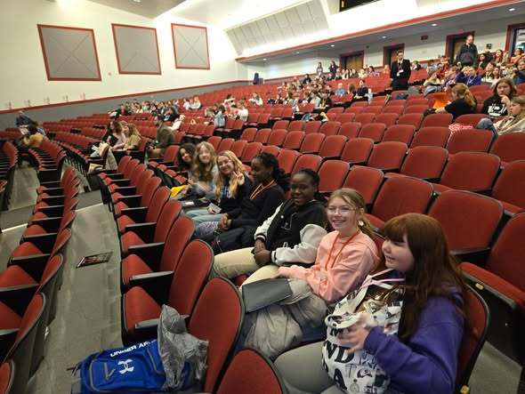 Students sitting in an auditorium. 