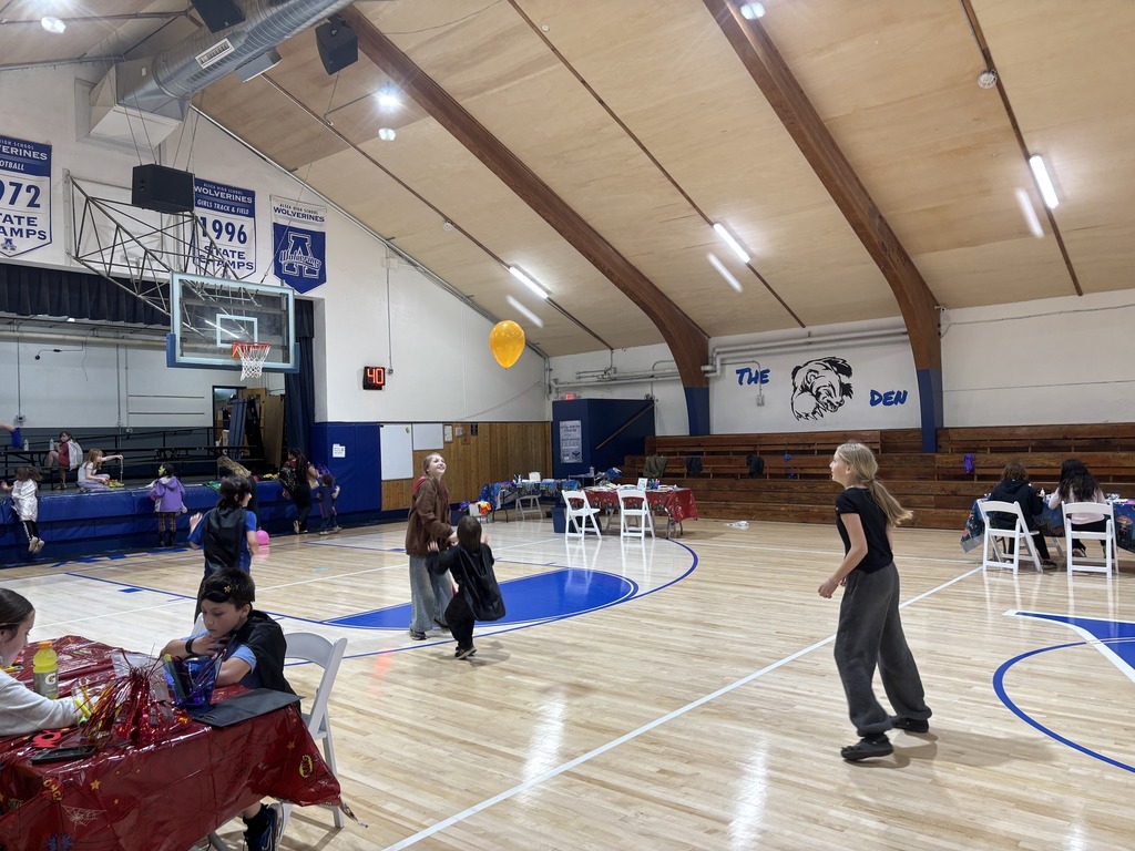 kids playing with balloon on basketball court