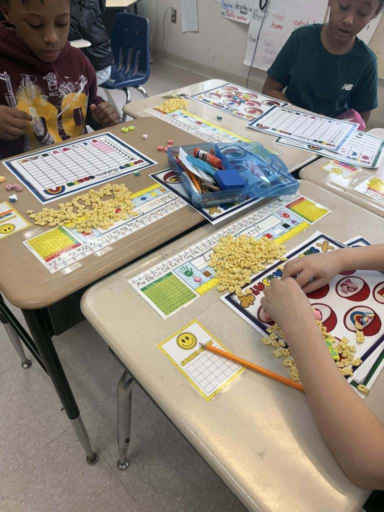 Students doing a counting activity by counting the number of different lucky charms they have. 