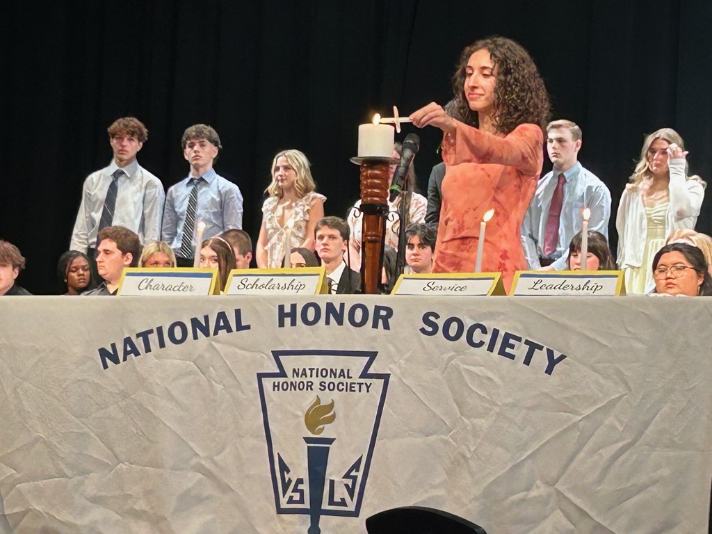 girl lighting a candle in the NHS ceremony