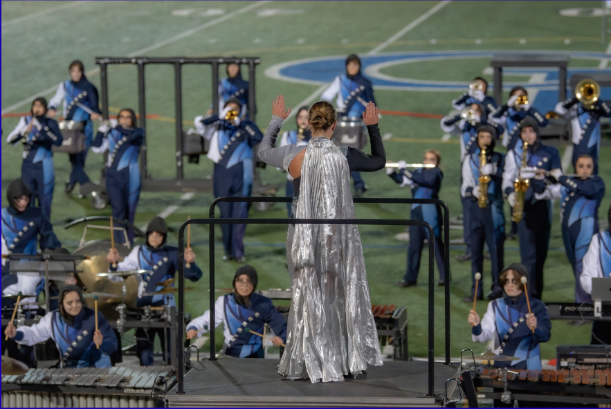 Band performing with conductor in the foreground