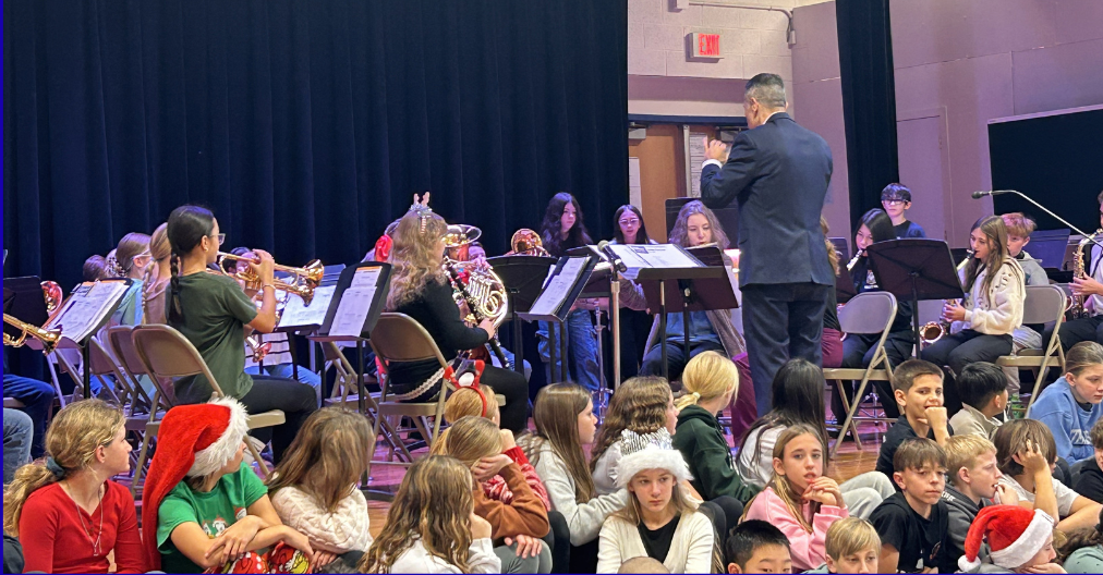 Band performing with conductor in the foreground