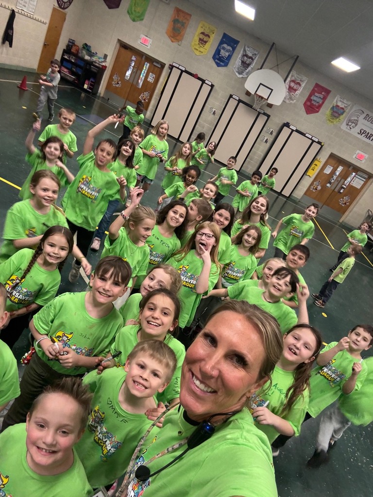 Mrs. Flores and the students who raised $50 or more in green tshirts