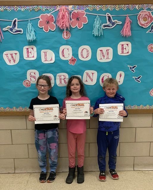 1st grade Students of the Month standing together with their certificates in hand