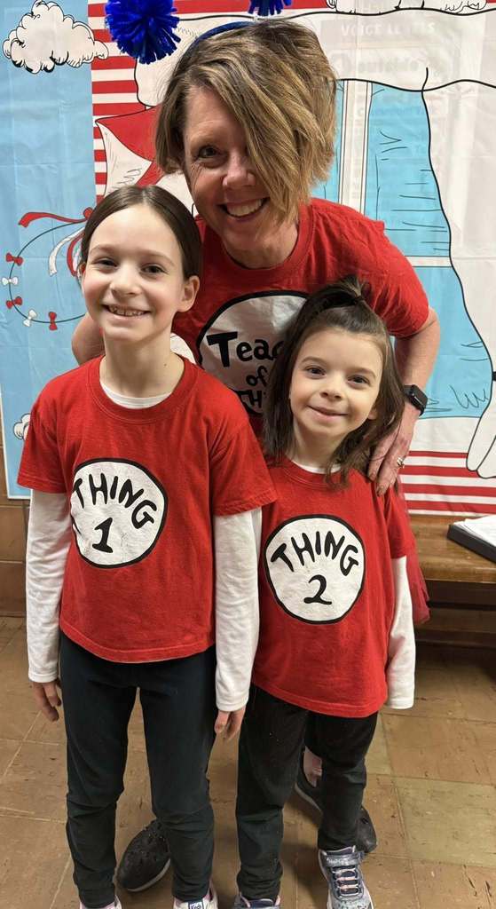 A teacher and students dressed as thing one and thing two from Dr. Suess books. 