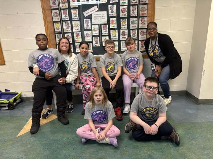 Students and teachers wearing gray JoAnna Connell T-Shirts.