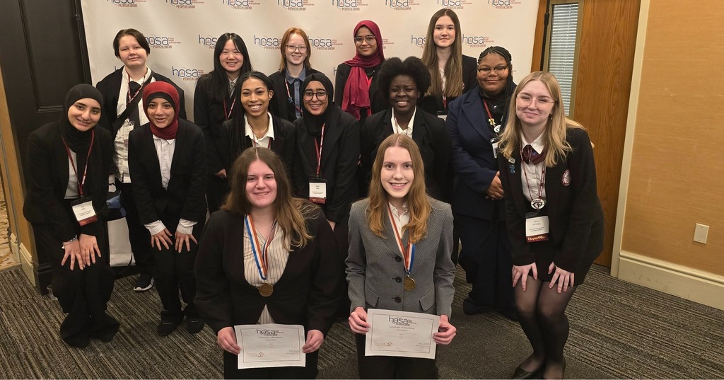 A group of students holding their HOSA awards.