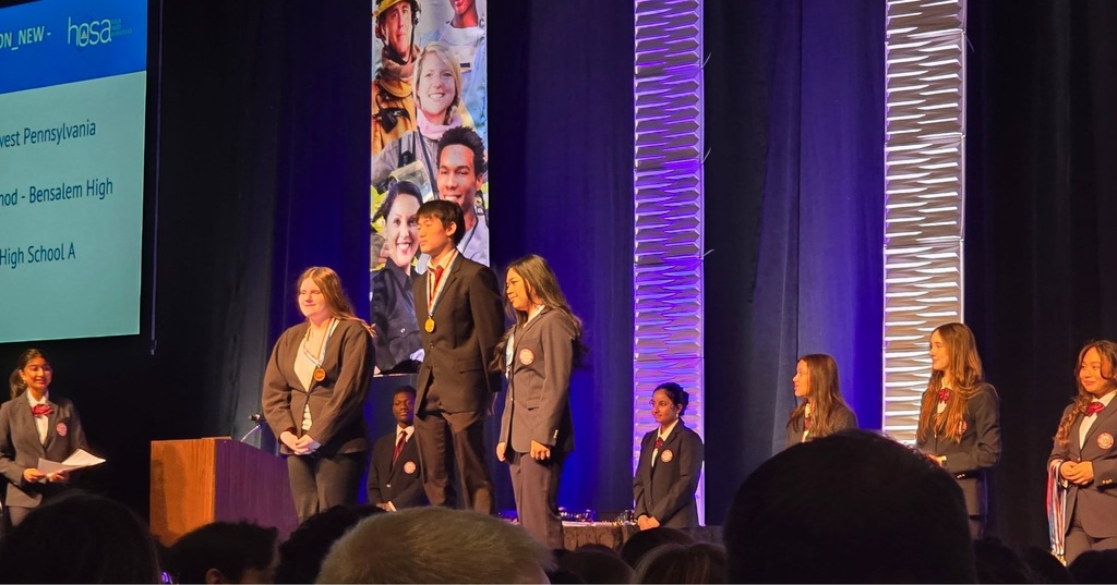 Students on stage being announced as winners. 