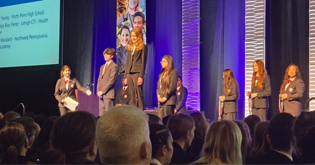 Students on stage being announced as winners. 