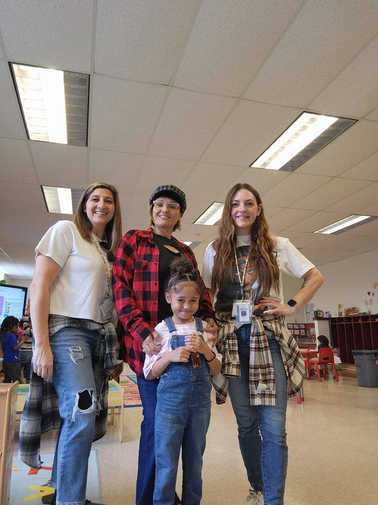 A teachers and a student dressed as people have in the 90s. 