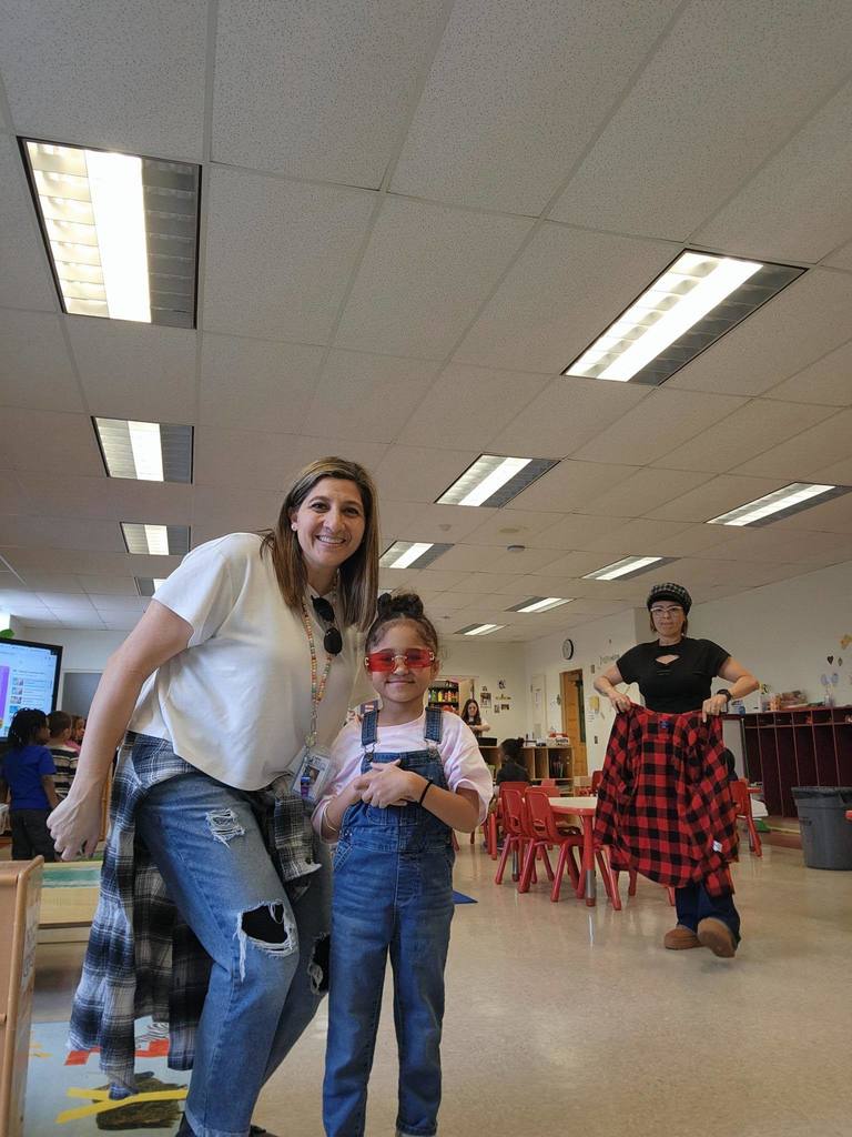 A teacher and student dressed as people have in the 90s. 