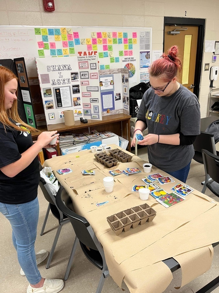 students planting flowers
