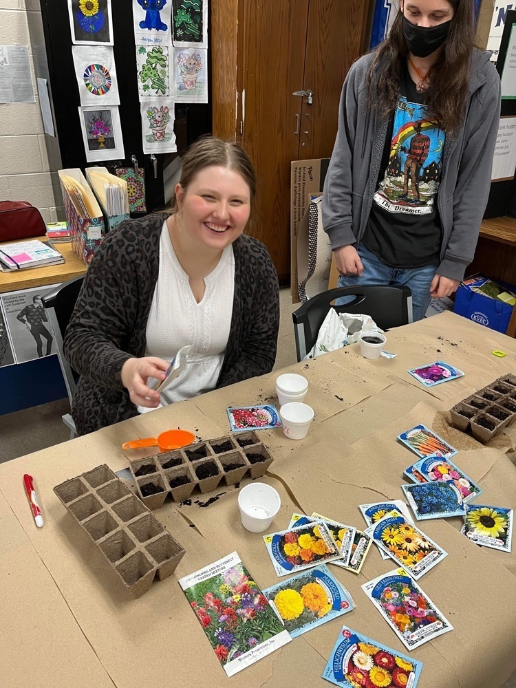 students plant flowers