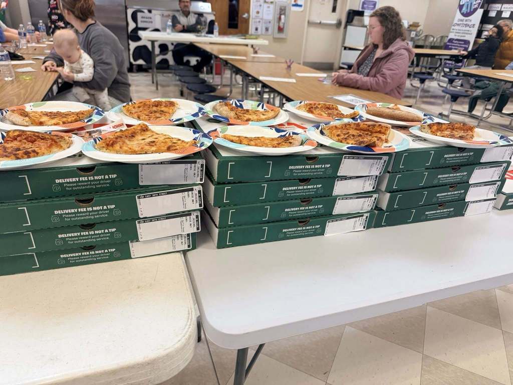 Pizza on plates that are places on top of pizza boxes.