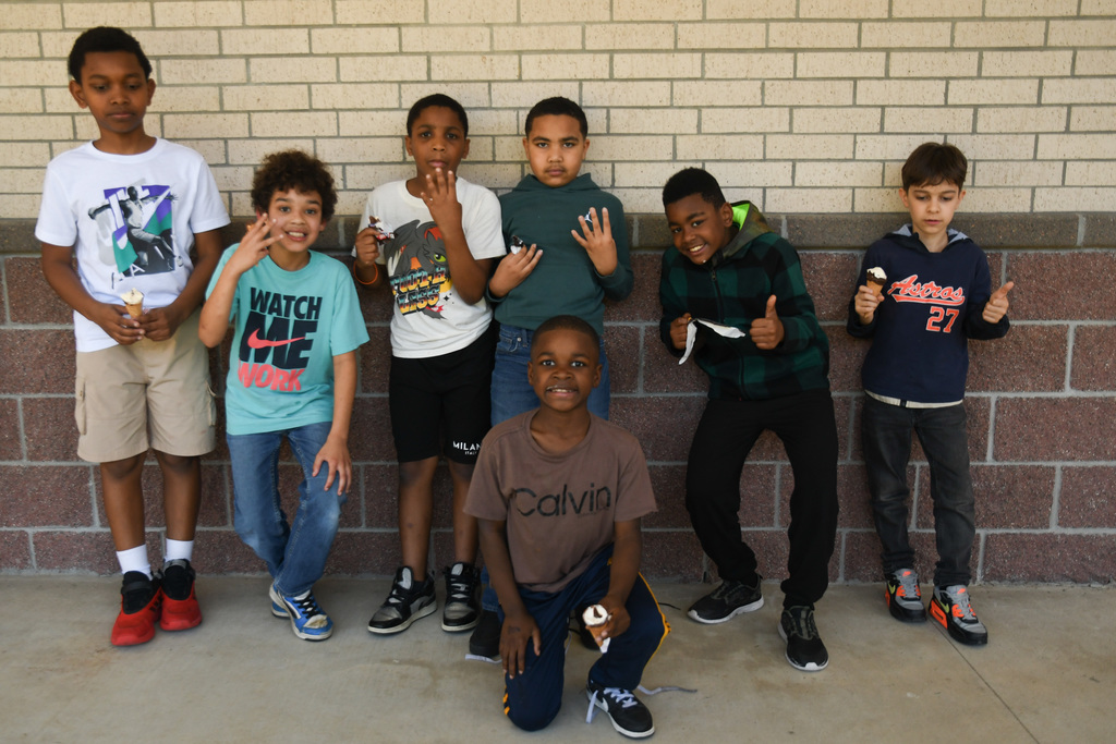 group of boys posing for a photo with ice cream