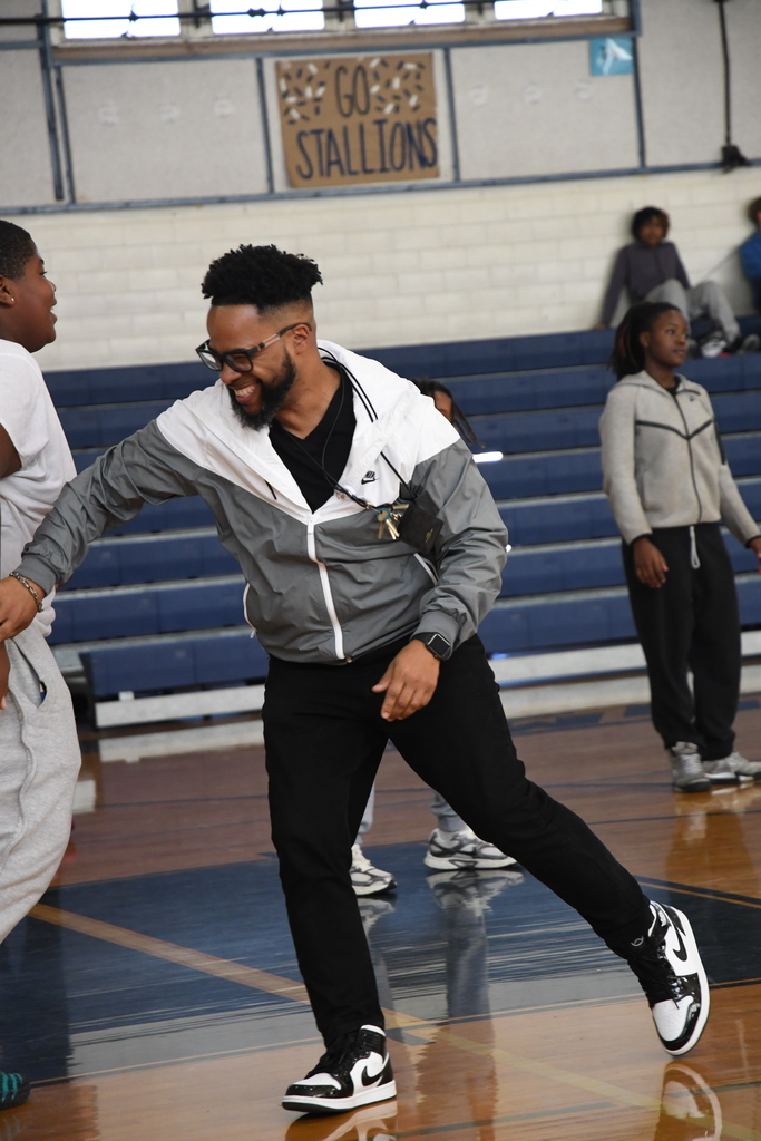 Principal playing basketball with students