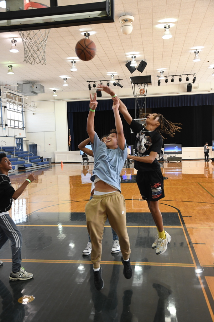 student taking a shot in basketball